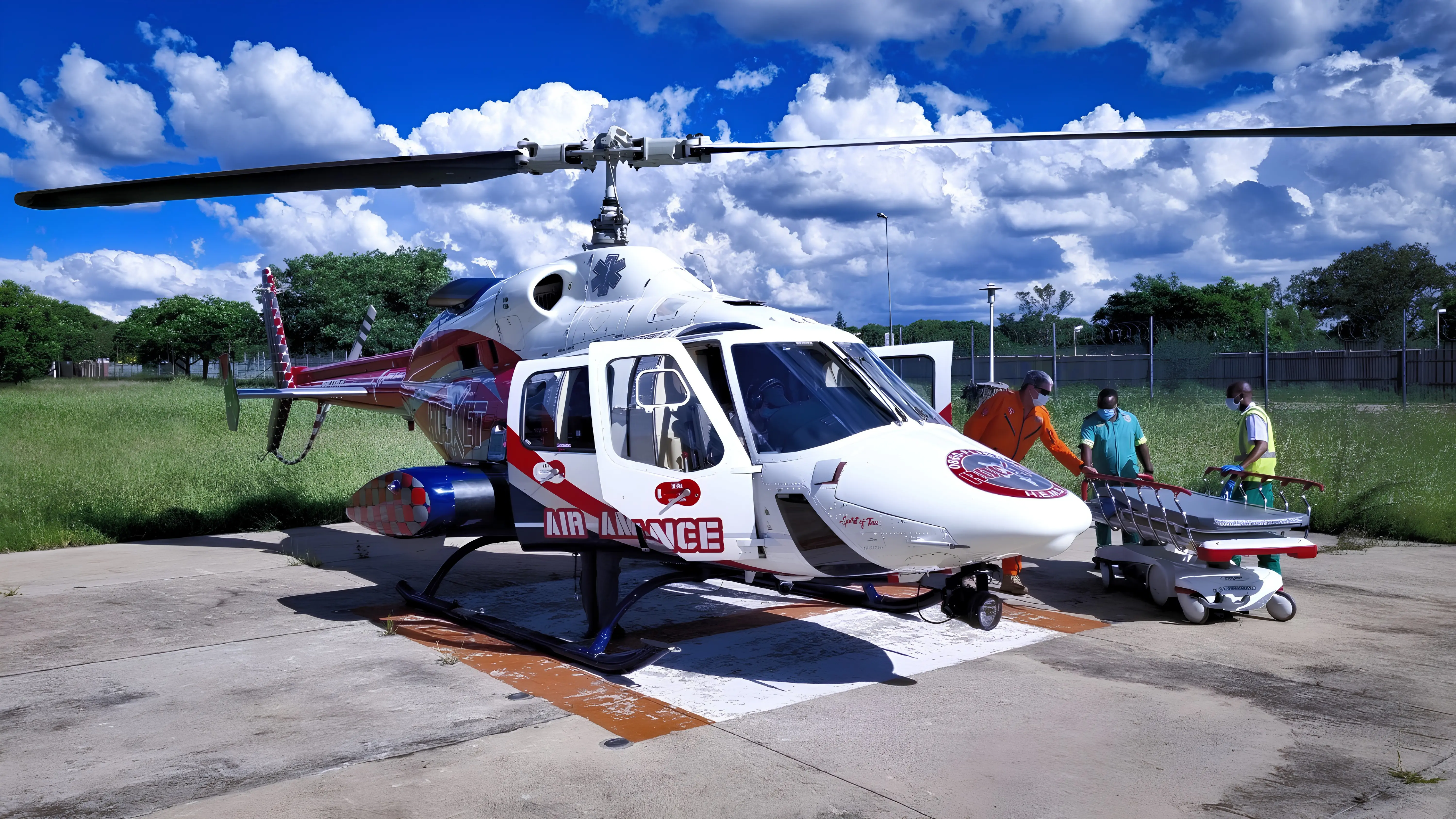 Emergency medical team preparing a patient for helicopter transport